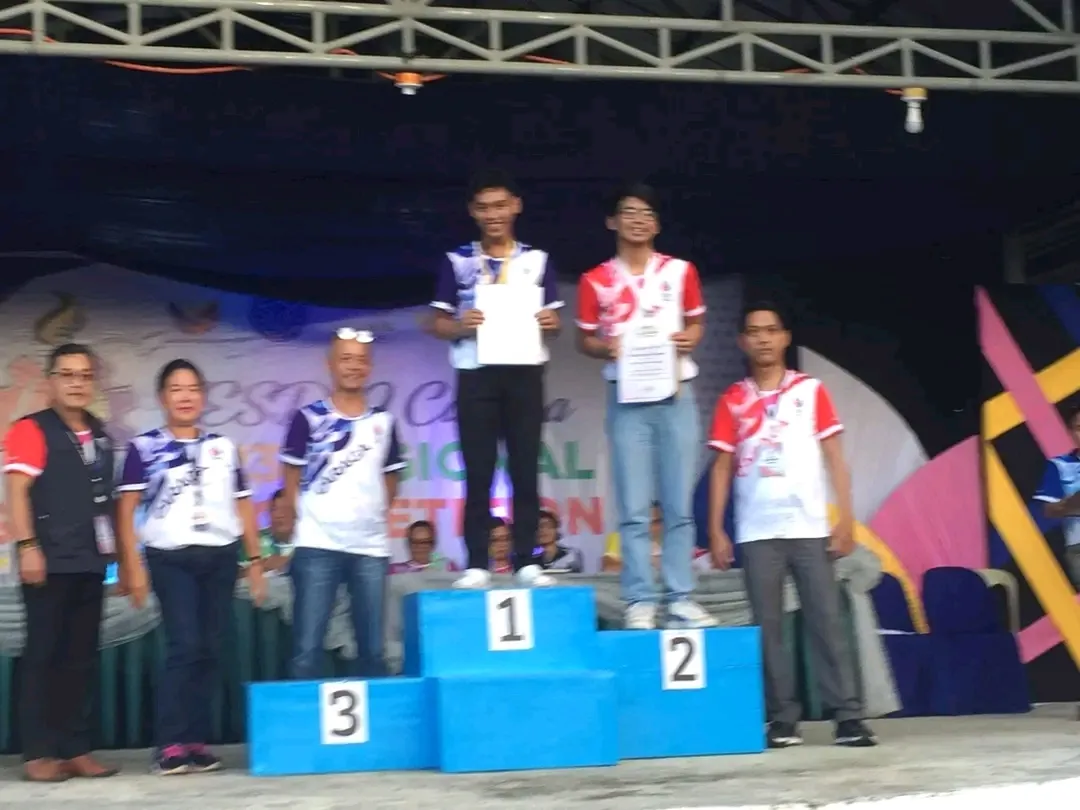 Joshi standing on the first-place podium at the regional skills competition