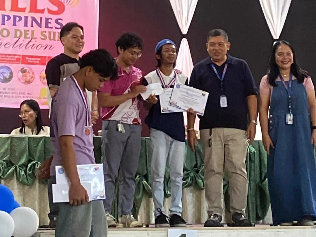 Joshi and his silver-medal competitor on stage holding their certificates at the 2026 WorldSkills Philippines Surigao del Sur Competition